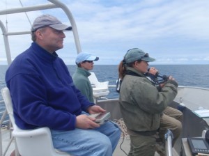Harry Carter, Dani Lipski, and Laurie Harvey surveying seabirds from the flying bridge. Harry is holding the Husky computer.