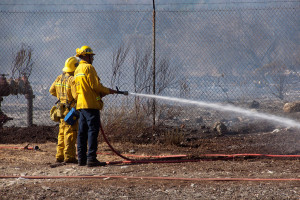 4:35 PM - Firefighters douse hot spots in the Foothill Blvd parkway. Nancy Hamlett.