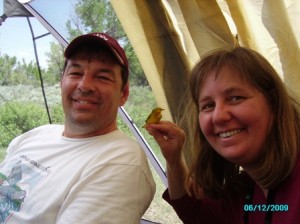 Nina and John holding a yellow warbler