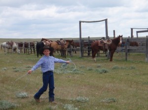 Young cowboy practising roping